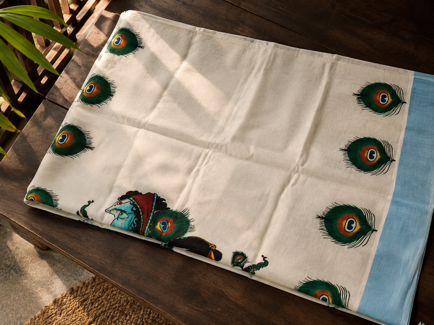 Krishna peacock printed Kerala saree with sky blue border